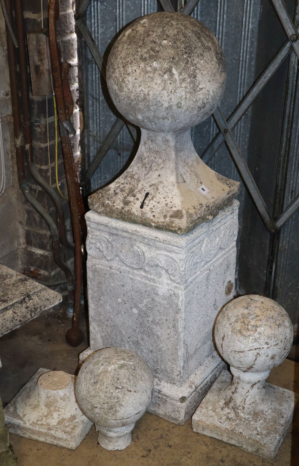 Three reconstituted stone garden ball finials, (one on pedestal) H.104cm